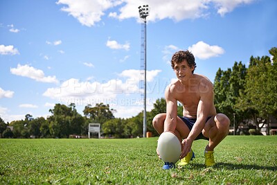 Buy stock photo Man, rugby ball and ready to kick on field with thinking, aim and target for challenge, training and fitness. Athlete, vision and prepare for sports, game or workout on grass field with wellness
