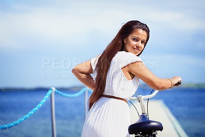 Buy stock photo Woman, portrait and sea on pier with bike for adventure, smile or transport on vacation in sunshine. Girl, person and bicycle by waves, ocean or water by bridge, promenade or dock on holiday in Italy