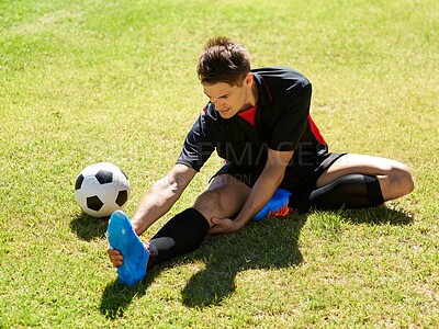Buy stock photo Man, field and football for training with stretching on practice for match, fitness and competitive in Spain. Male person, player and exercise for sport or soccer career with warm up for game.