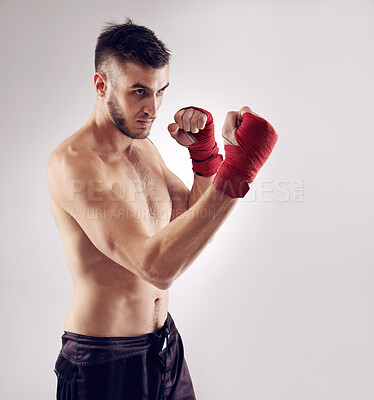 Buy stock photo Fist, MMA and male fighter for martial arts pose, boxing and angry on white background. Wraps, hands and athlete for exercise and man kickboxer, studio and training for impact sports competition