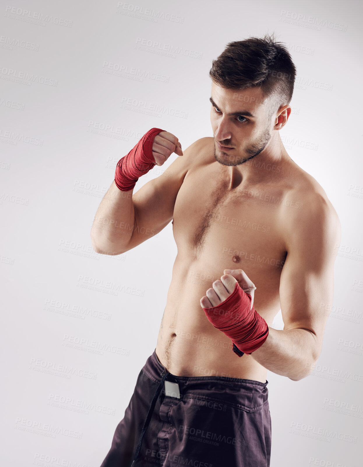 Buy stock photo Fist, MMA and wraps for male fighter or boxer, pose and boxing on white background. Fitness, hands and athlete for exercise and man kickboxer, studio or training for impact sports or competition