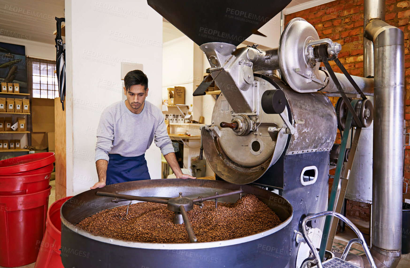 Buy stock photo Coffee, checking and man with machine for roasting with small business, production and quality control. Entrepreneur, barista or roaster with beans at cafe, sustainable startup and espresso process