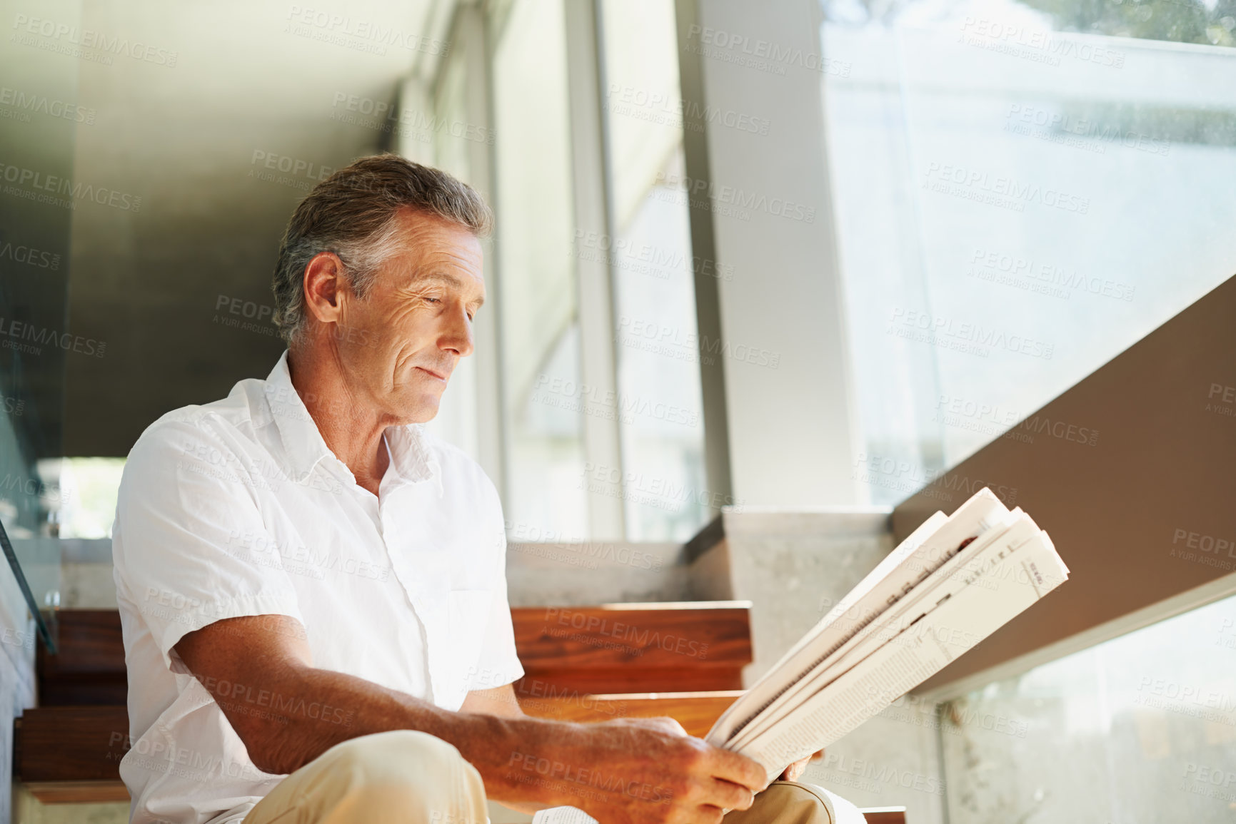 Buy stock photo Old man, reading and newspaper in home or article for global current events, stock market or journalism. Male person, stairs and press information with opinion report in living room, relax or review