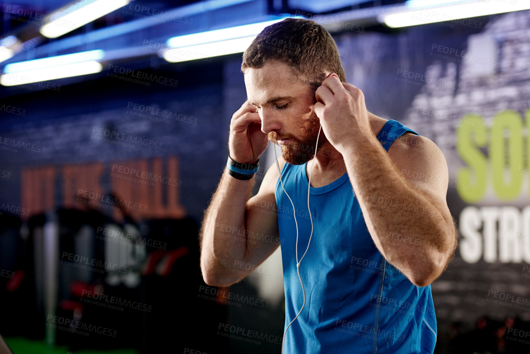 Buy stock photo Gym, man or listen to music, motivation or fitness podcast to focus on workout, training or exercise. Earphones, guy or audio to relax, warm up or confident of cardio as vision of health and wellness