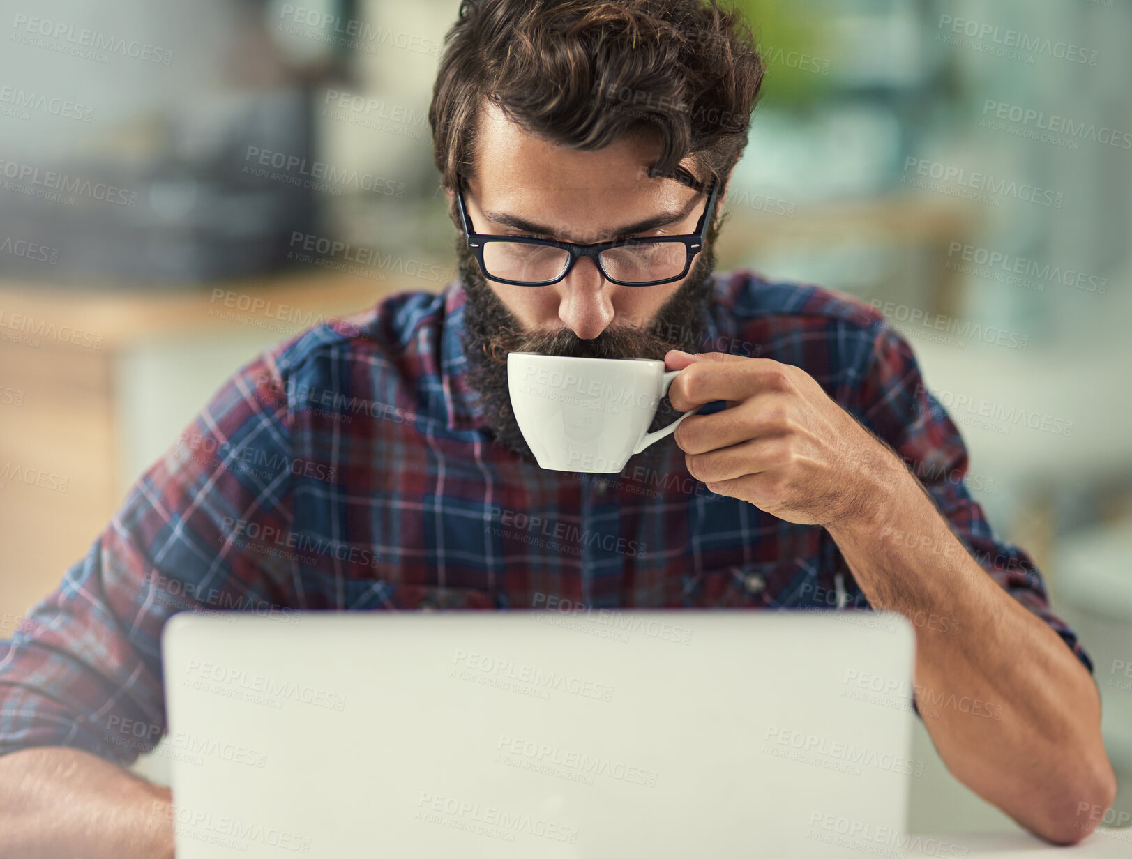 Buy stock photo Man, laptop and coffee in office for agency with online connection, reading email and web design software. Male designer, beverage and technology in creative workspace with tattoo, wordpress and wifi