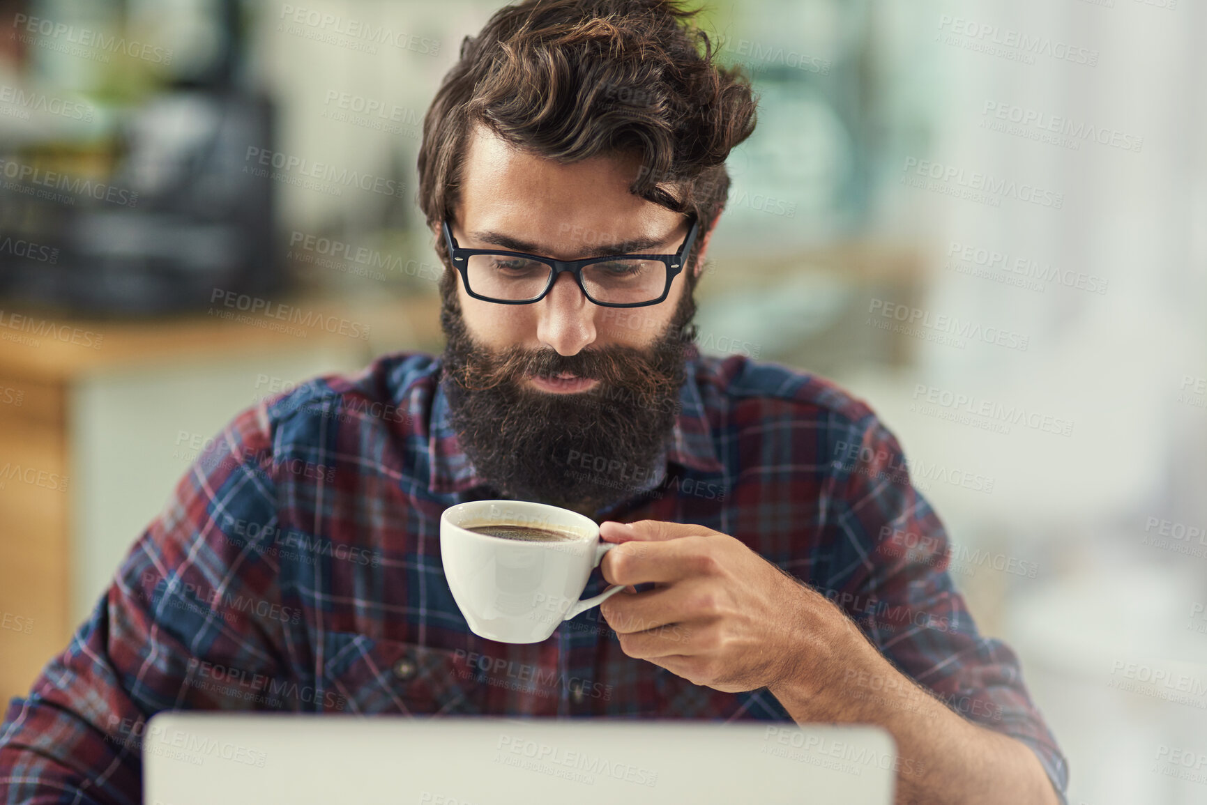 Buy stock photo Man, laptop and coffee in workplace for agency with online connection, reading email and web design software. Male designer, beverage and technology in modern office with tattoo, wordpress and wifi