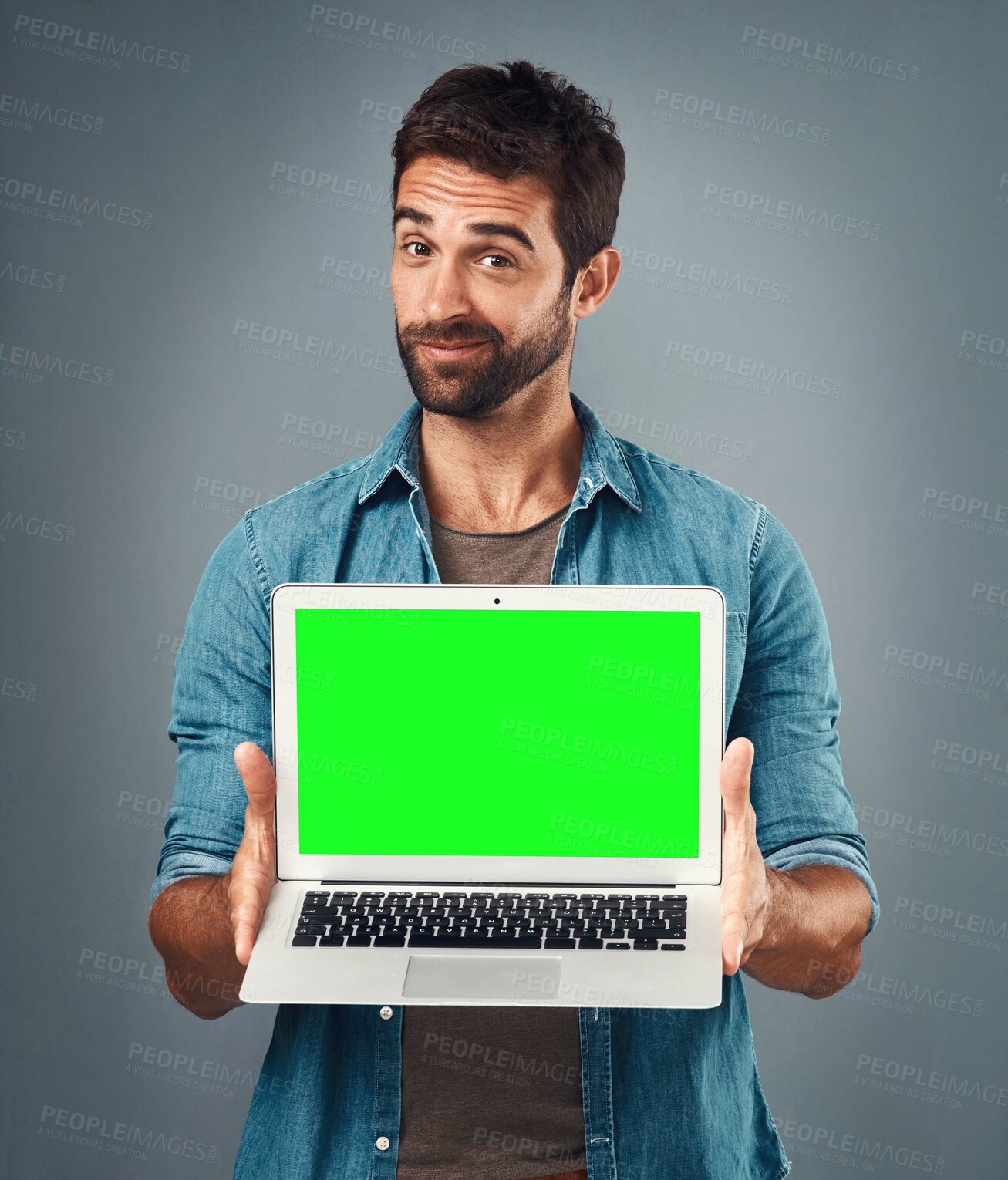 Buy stock photo Man, laptop and portrait with mockup green screen for advertising or marketing against a grey studio background. Male person showing computer display, chromakey or mock up space for advertisement
