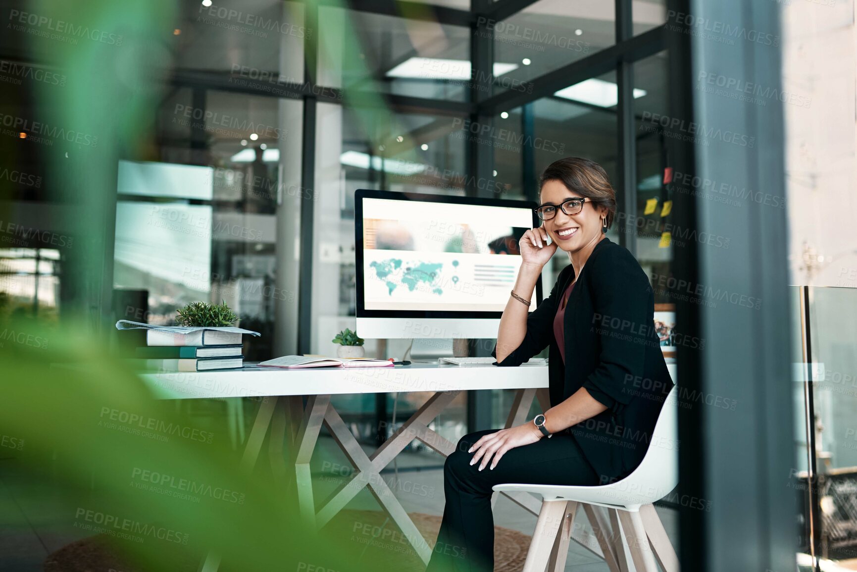 Buy stock photo Cropped portrait of an attractive young businesswoman sitting alone at her desk in her office