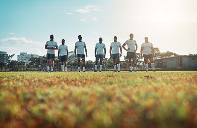 Buy stock photo Rearview shot of a group of young rugby players standing on a field