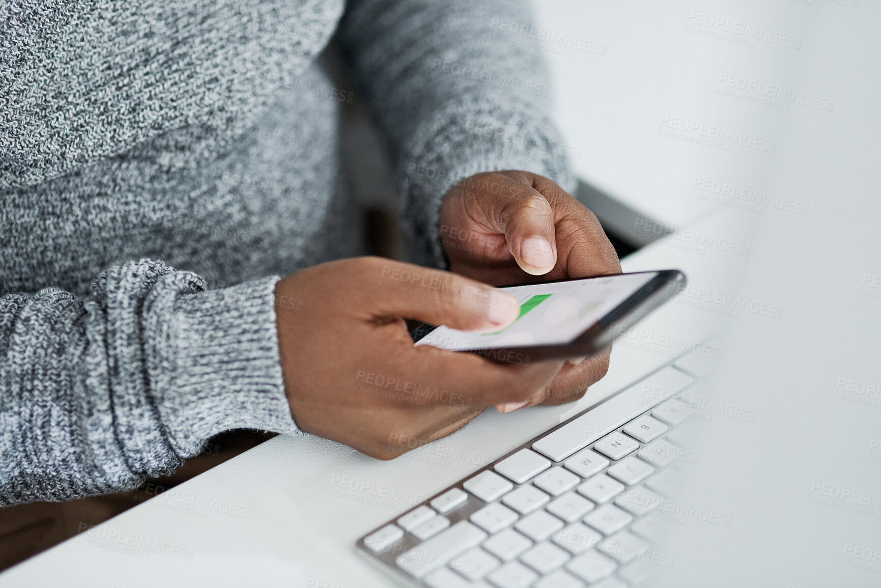 Buy stock photo Cropped shot of an unrecognizable businessman sitting alone in the office and using his cellphone