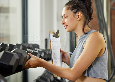 Buy stock photo Checklist, exercise and inspection with personal trainer woman checking equipment or weights in gym. Dumbbell, fitness and quality control with coach in training center for inventory compliance