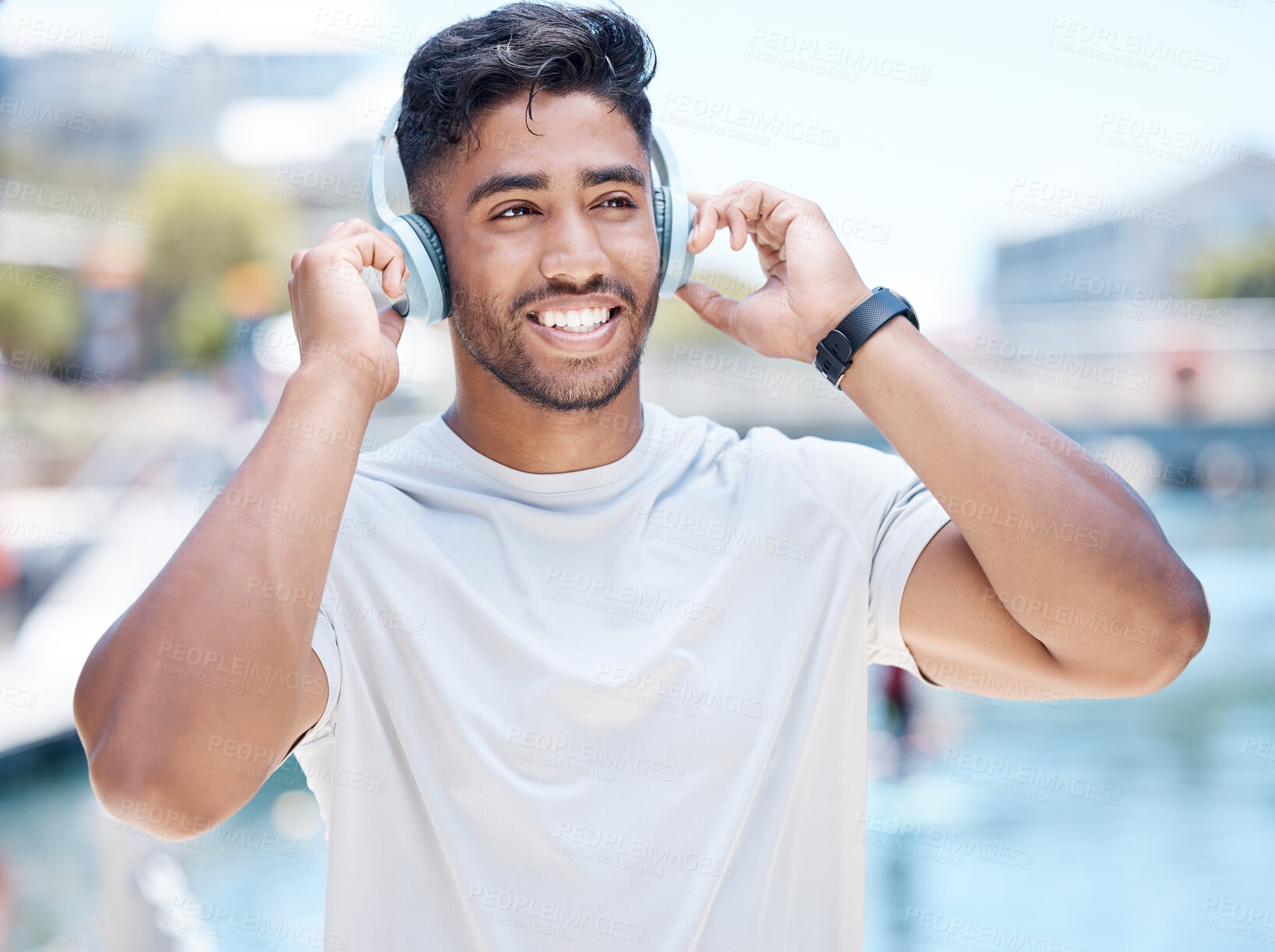 Buy stock photo Man, listen and headphones outdoor for fitness, music or audio streaming with personal trainer in city. Confident, happy and athlete with wireless tech for radio, podcast or playlist with training