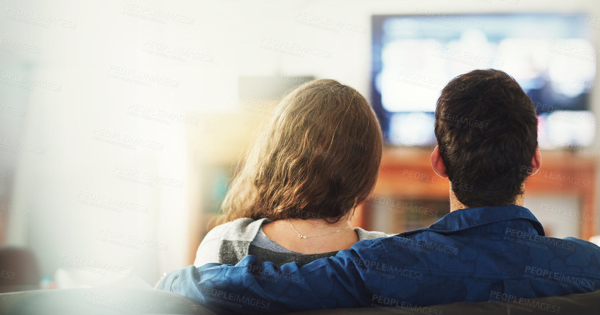 Buy stock photo Love, hug and couple watching tv on a sofa with streaming, service or sign up subscription. Television, movie and back or people in living room with cinema film, show or media in their home together