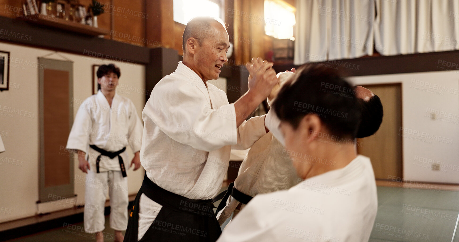 Buy stock photo Aikido class, man and sensei for martial arts, learning and advice for combat at training, gym and dojo. Japanese people, master and sports with fight, workout and fitness for zen, conflict or club