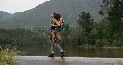 Nature, backpack and young woman hiking in forest on vacation, adventure or weekend trip. Travel, walking and female person trekking for fun in outdoor woods with bag for exploring on holiday.