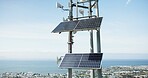 Solar panel, energy and roof with skyline, city and ocean with sustainability, power or off grid development. Photovoltaic tech, electricity and outdoor with blue sky background with buildings by sea