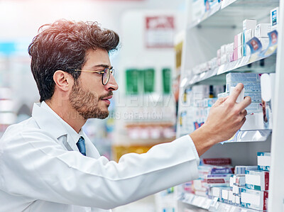 Buy stock photo Pharmacist, reading medicine and man in pharmacy while working in store for retail career. Male person in pharmaceutical or medical industry for service, healthcare and inventory check on shelf