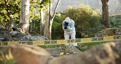 Forensic, photographer and evidence at crime scene for investigation in forest with police tape and safety hazmat. Csi quarantine, expert investigator and pictures for observation and case research