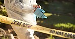 Forensic, gloves and police tape at crime scene for investigation, getting ready and hazmat for protection. Csi quarantine, expert investigator and outdoor for observation, evidence and case research