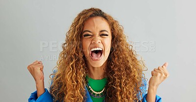Excited woman, fist pump and celebration with deal, promotion or winning on a gray studio background. Portrait of happy female person or young winner with smile in surprise for bonus on mockup space