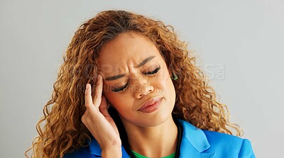 Frustrated woman, headache and stress with anxiety, mental health or depression on a gray studio background. Face of tired female person in fatigue, pressure or tension with overwhelmed emotion