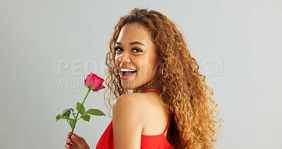 Woman, happy and rose in studio with smile for gift, kindness and gratitude with scent or fragrance on a white background. Face of excited, African person or model with pink flower for valentines day
