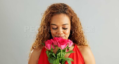 Happy woman, roses and valentines day with flowers for love, care or romance on a gray studio background. Portrait of female person with smile, bouquet and plant for romantic gift on mockup space