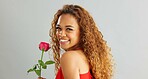 Young, woman and rose in studio with smile for gift, kindness and gratitude with scent or fragrance on a white background. Face of excited, African person or model with pink flower for valentines day