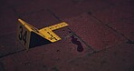 Crime scene, investigation and blood on floor for evidence, forensics and dna for pathology research. Marker, security and yellow sign with number for warning, caution and incident on red bricks