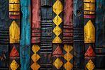African art, wall and ancient background engraving with creative pattern in painting of culture. Temple, decoration and carving of shape in surface with gold, blue and red on stone in tribal mural