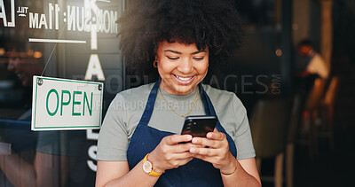 Happy black woman, phone and open cafe by door for communication, social media or networking. African female person or waitress smile on mobile smartphone in online chatting or texting at coffee shop