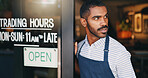 Man, coffee shop and open sign on front door with waiting for customer, thinking and service in morning. Waiter, server or small business owner at cafeteria with board for welcome to store for drink