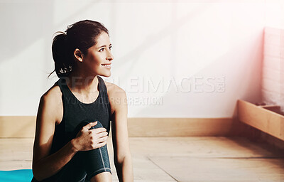 Buy stock photo Shot of an attractive young woman taking a break while exercising at home