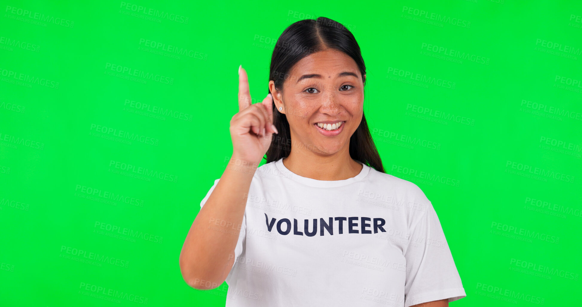 Buy stock photo Pointing, volunteer and portrait of Asian woman on green screen for announcement, news and information. NGO, mockup and person with hand gesture for non profit, community service and help in studio