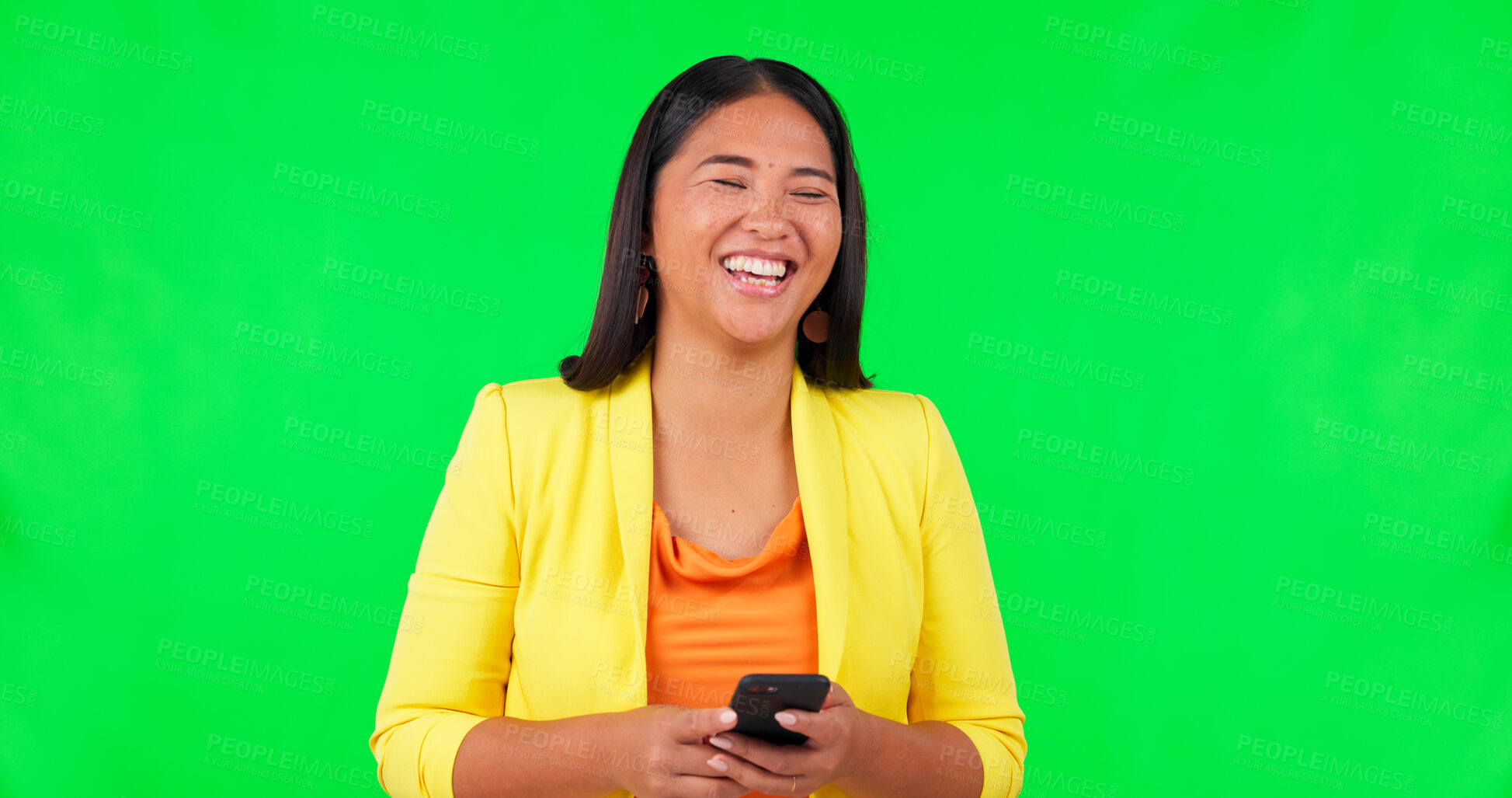 Green screen, typing and happy woman laughing with phone for joke, silly or  funny humor in studio. Online, comedy and Asian female person reading app,  text or social media comic meme while