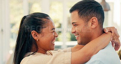 Laughing, face and a happy couple embrace at home with love, care and romance. Young woman and a man together in an apartment to hug, relax and bond for happiness, quality time and commitment