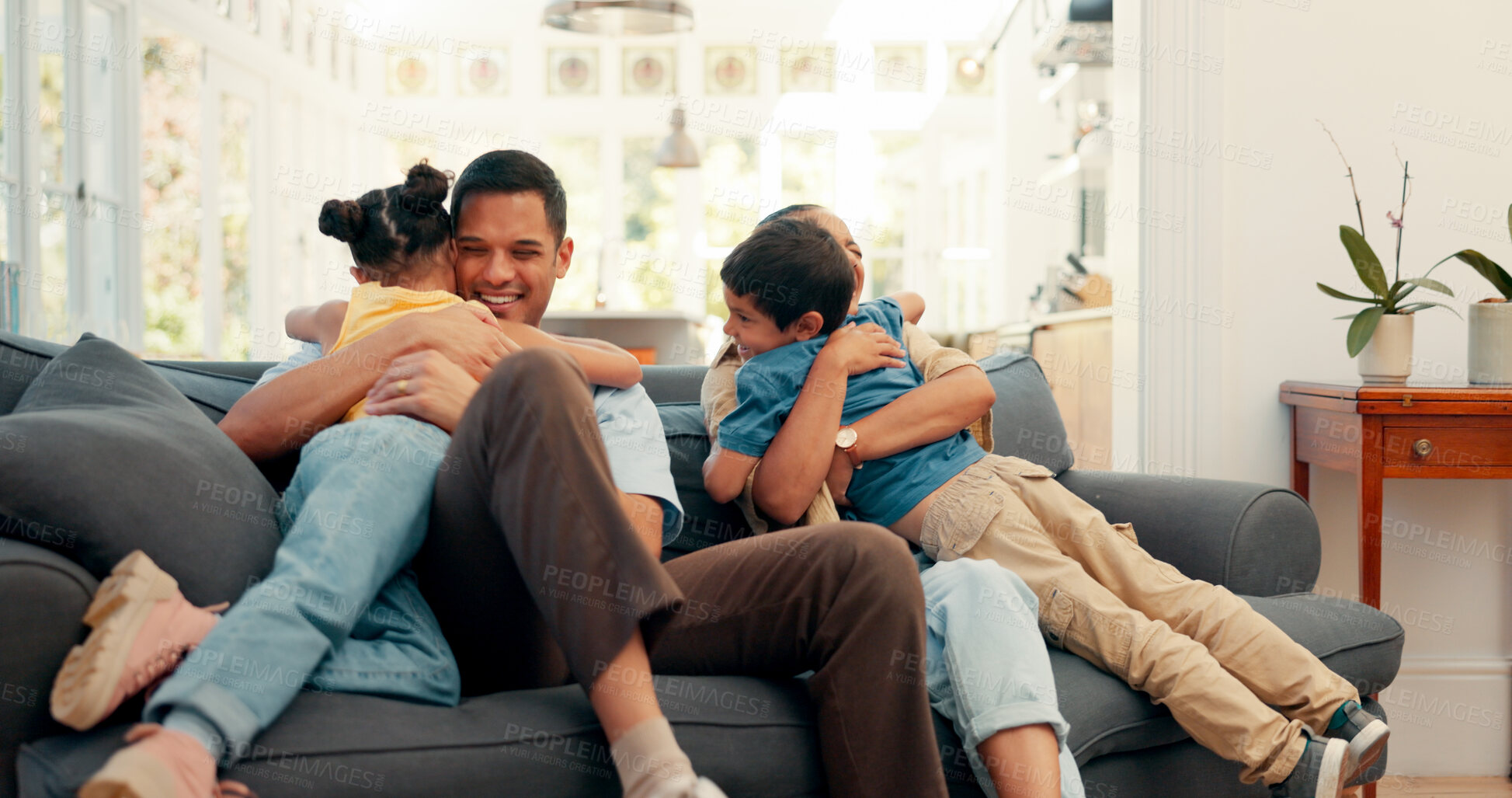 Buy stock photo Happy family, love and hug on a sofa with care, security and support, bonding and comfort at home. Safety, trust and children embrace parents in living room for weekend, vacation or house staycation