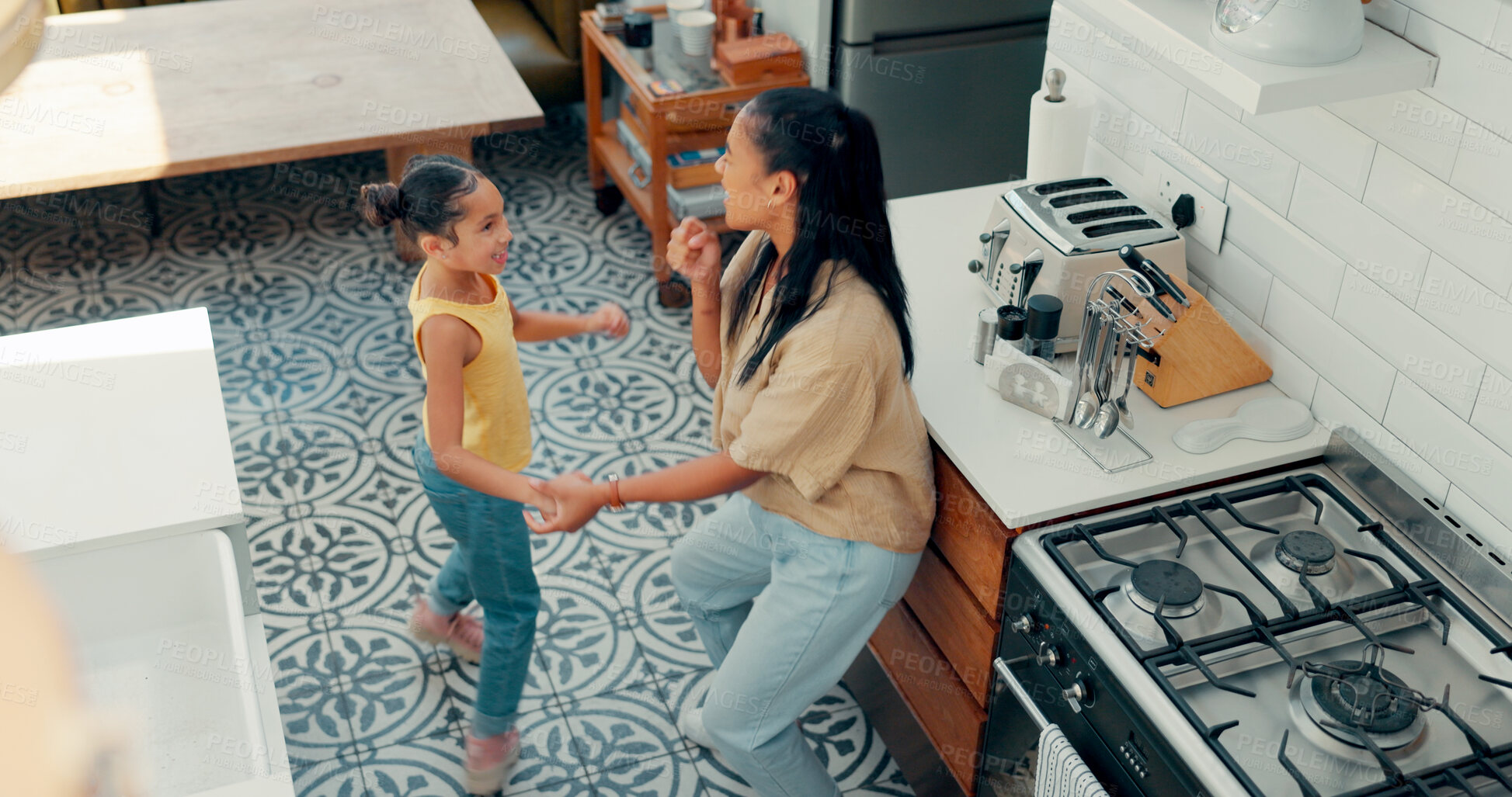 Buy stock photo Mother, child and happy dance in kitchen with energy, fun and bonding for quality time together from above. Mom, young girl kid and singing in home for celebration, dancing and excited for music