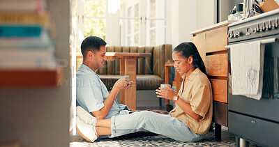 Talking, coffee and a happy couple at home with love, care and communication. Young woman and man laughing while drinking tea together to bond for happiness, quality time and conversation on a floor