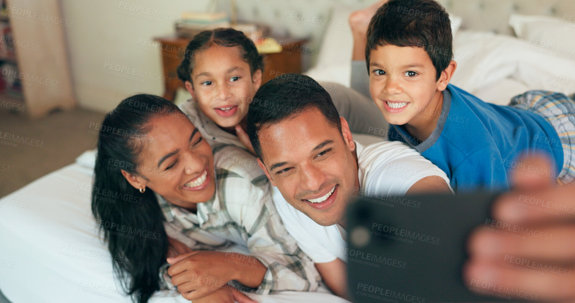 Buy stock photo Selfie, family and happy or relax on bed for memory, social media post and profile picture update in home. Parents, children and bonding together in the bedroom with waking up, photo and morning fun