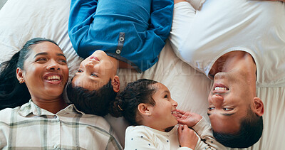 Conversation, relax and parents talking to their children on the bed while having fun, resting and bonding. Happiness, smile and young kids speaking with their mother and father in bedroom at home.