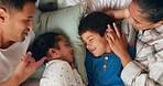 Love, bonding and kids sleeping by their parents in the bed for cuddling in their family house. Sweet, happy and sibling children taking a nap with their mother and father in their bedroom at home.