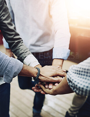 Buy stock photo Shot of a group of unrecognizable work colleagues forming a huddle with their hands outside during the day