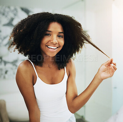 Buy stock photo Portrait of an attractive young woman going through her morning haircare routine