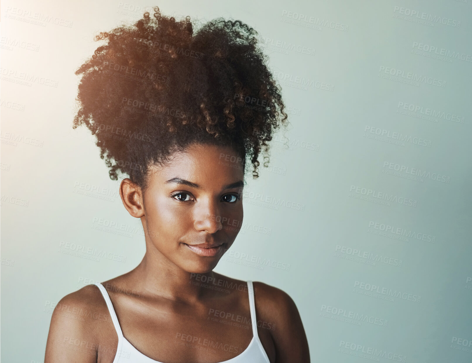 Buy stock photo Portrait, skincare and beauty of black woman with glow in studio isolated on gray background. Face, makeup and confident model in cosmetics with curly hairstyle at salon for health, shine or mockup