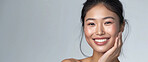 Beauty, mockup and portrait of asian woman with smile in studio isolated on gray background. Face, skincare and space for wellness with happy or natural young model at cosmetic or dermatology spa