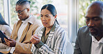 Anxiety, interview and woman in waiting room with candidates at recruitment agency. Human resources, hiring and fear, men and women in lobby with hope, motivation and stress for new job opportunity.