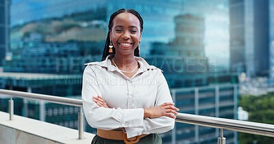 Black woman, face and arms crossed, lawyer happy with career and confident on rooftop, skyscraper and pride. Expert, legal employee or attorney with smile in portrait for corporate and professional