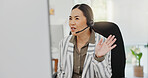 Asian woman, call center and wave in virtual meeting, discussion or customer service at the office. Friendly female person, consultant or agent talking on computer in hello for webinar at workplace