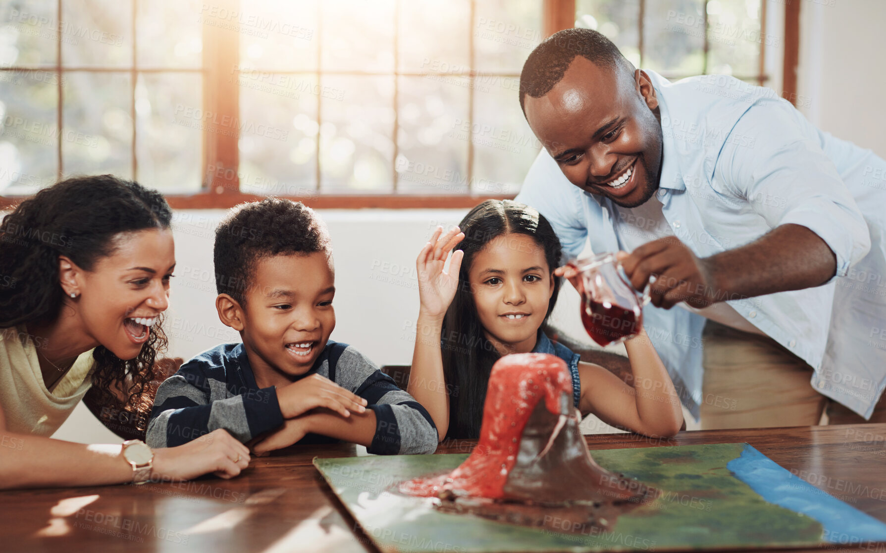 Buy stock photo Cropped shot of a young couple helping their kids with a school project
